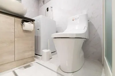 a white bathroom with a toilet and a sink at belle ville \u795e\u697d\u5742 in Tokyo