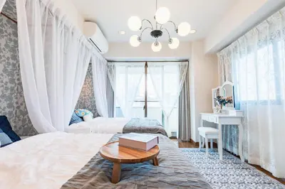 a bedroom with a bed and a table and a desk at HARMONIA\u6771\u4eac\u5800\u5207403 in Tokyo