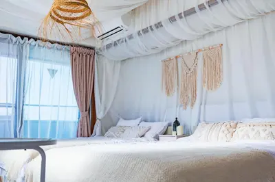 a bedroom with a large white bed and a window at HARMONIA\u6771\u4eac\u5800\u5207502 in Tokyo