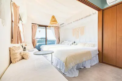 a bedroom with two beds and a table in it at HARMONIA\u6771\u4eac\u5800\u5207502 in Tokyo