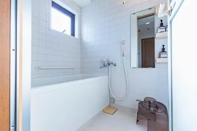 a white bathroom with a tub and a sink at HARMONIA\u6771\u4eac\u5800\u5207502 in Tokyo