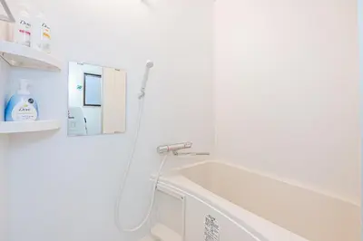 a white bathroom with a sink and a mirror at Bright Modern Airbnb in Tokyo's Northern District in Tokyo