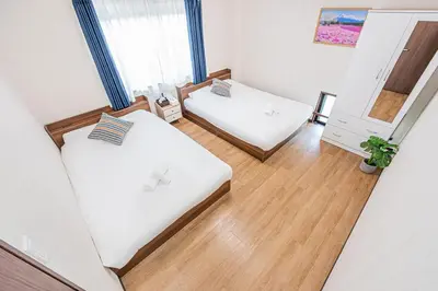 a small room with two beds and a mirror at Bright Modern Airbnb in Tokyo's Northern District in Tokyo