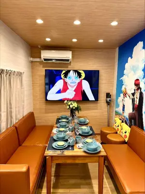 a living room with a table and a tv at Itabashi Ekimae - Diamond Yu in Tokyo