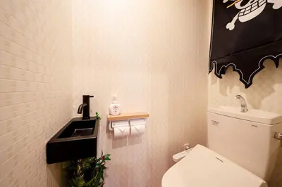 a small bathroom with a toilet and a sink at Itabashi Ekimae - Diamond Yu in Tokyo