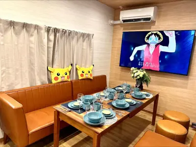 a living room with a couch and a table with glasses at Itabashi Ekimae - Diamond Yu in Tokyo