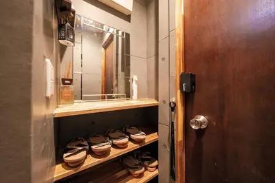 a row of shoes on a shelf in a bathroom at Itabashi Ekimae - Diamond Yu in Tokyo