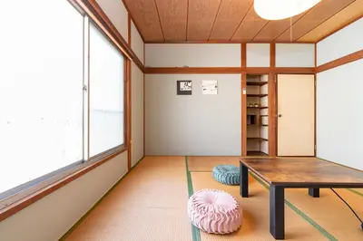 a room with a table and a book shelf at GuestHouse　YOU&I平和島 in Tokyo