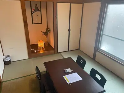 a conference room with a table and chairs and a window at GuestHouse　YOU&I平和島 in Tokyo