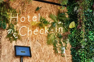 a sign that says hotel check in on a wall at BbyC APARTMENT 浅草花園通 レンタカー&サウナ付ホテル in Tokyo