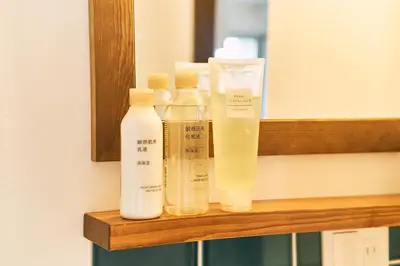 four bottles sitting on a shelf in a bathroom at BbyC APARTMENT 浅草花園通 レンタカー&サウナ付ホテル in Tokyo