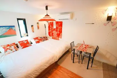 a bedroom with a bed and a table with chairs at The Baron\u897f\u65b0\u5bbf303\u30bb\u30eb\u30d5\u30b3\u30fc\u30d2\u30fc\u4ed8\u304d in Tokyo