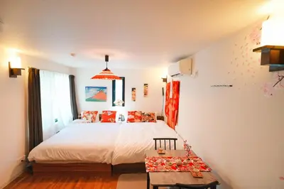 a bedroom with a large bed and a table at The Baron\u897f\u65b0\u5bbf303\u30bb\u30eb\u30d5\u30b3\u30fc\u30d2\u30fc\u4ed8\u304d in Tokyo