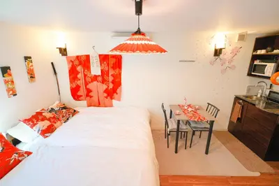 a bedroom with a bed and a dining room table at The Baron\u897f\u65b0\u5bbf303\u30bb\u30eb\u30d5\u30b3\u30fc\u30d2\u30fc\u4ed8\u304d in Tokyo