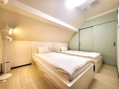 a small bedroom with two beds in it at New! Ten people Shin Ookubo 6minPocket WIFI in Tokyo
