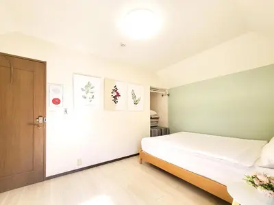 a bedroom with a bed and a door at New! Ten people Shin Ookubo 6minPocket WIFI in Tokyo