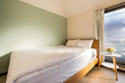 a small bedroom with a bed and a window at New! Ten people Shin Ookubo 6minPocket WIFI in Tokyo