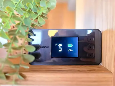 a cell phone sitting on a table next to a plant at New! Ten people Shin Ookubo 6minPocket WIFI in Tokyo