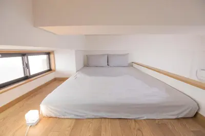 a large white bed in a room with a window at Shinjuku Ryokan Retreat丶Local Tokyo Experience & Short Trips Hub丶walk to Higahsi Shinjuku station Y02f in Tokyo