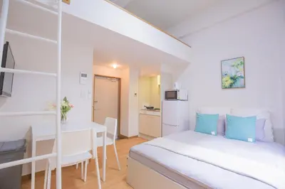 a white bedroom with a bed and a desk at Shinjuku Ryokan Retreat丶Local Tokyo Experience & Short Trips Hub丶walk to Higahsi Shinjuku station Y02f in Tokyo
