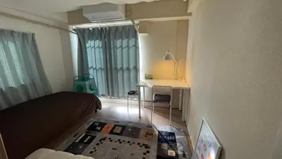 a bedroom with a bed and a desk and a window at Terminal in Takadanobaba in Tokyo