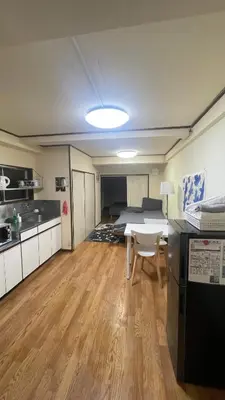 a kitchen with a table and a bed in a room at Terminal in Takadanobaba in Tokyo