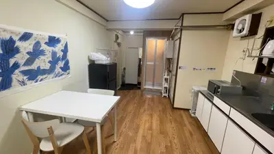 a kitchen with a table and chairs in a room at Terminal in Takadanobaba in Tokyo