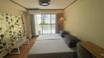 a small room with two beds and a window at Terminal in Takadanobaba in Tokyo