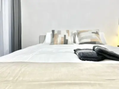 a pair of gloves laying on a white bed at Nishiwaseda-SJ0178 in Tokyo