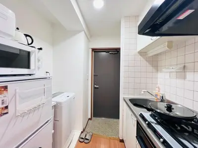 a small kitchen with a sink and a microwave at Nishiwaseda-SJ0178 in Tokyo