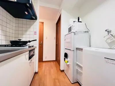 a kitchen with a white refrigerator and a sink at Nishiwaseda-SJ0178 in Tokyo