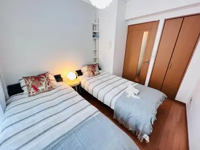 two beds in a small room with a lamp at Nishiwaseda-SJ0178 in Tokyo