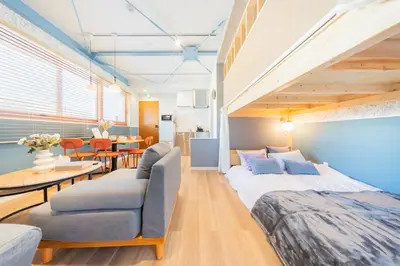 a room with a bed and a couch and a table at Tokyo Skytree sta 2min walk, 2stop Asakusa sta-Stay SUU & Cafe- in Tokyo