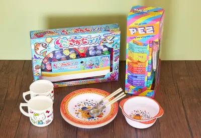 a table with a box and two plates and cups at Est house KAMEARI -Entire Tokyo House with Direct Bus Access to Airport and Disney in a Peaceful Local Neighborhood with 24 Hour Shops and Dining Options- in Tokyo