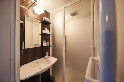 a bathroom with a sink and a mirror at Est house KAMEARI -Entire Tokyo House with Direct Bus Access to Airport and Disney in a Peaceful Local Neighborhood with 24 Hour Shops and Dining Options- in Tokyo