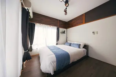a bedroom with a bed and a window at Est house KAMEARI -Entire Tokyo House with Direct Bus Access to Airport and Disney in a Peaceful Local Neighborhood with 24 Hour Shops and Dining Options- in Tokyo
