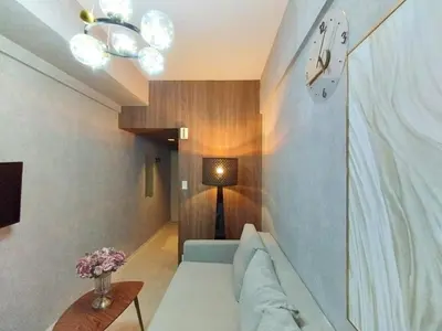 a living room with a couch and a clock on the wall at Z22\u65b0\u5bbf\u6700\u4e2d\u5fc3 \u6771\u65b0\u5bbf\u7ad95\u5206-Shinjuku center 5 mins to Station, Max 4 \u76f4\u8fbe\u65b0\u5bbf \u6d89\u8c37 \u8868\u53c2\u9053 \u6c60\u888b \u4e0a\u91ce \u4ee3\u4ee3\u6728 \u94f6\u5ea7 \u539f\u5bbf in Tokyo