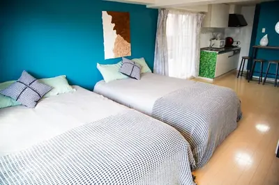 two beds sitting next to each other in a room at S19\u65b0\u5bbf\u6700\u4e2d\u5fc3 \u6771\u65b0\u5bbf\u7ad95\u5206-Shinjuku center 5 mins to Station, Max 6P \u76f4\u8fbe\u65b0\u5bbf \u6d89\u8c37 \u8868\u53c2\u9053 \u6c60\u888b \u4e0a\u91ce \u4ee3\u4ee3\u6728 \u94f6\u5ea7 \u539f\u5bbf in Tokyo