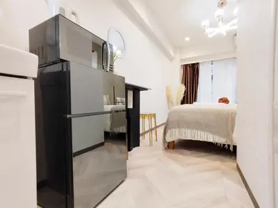 a kitchen with a black refrigerator and a bedroom at G53\u65b0\u5bbf\u6700\u4e2d\u5fc3 \u6771\u65b0\u5bbf\u7ad95\u5206-Shinjuku center 5 mins to Station, Max 4P \u76f4\u8fbe\u65b0\u5bbf \u6d89\u8c37 \u8868\u53c2\u9053 \u6c60\u888b \u4e0a\u91ce \u4ee3\u4ee3\u6728 \u94f6\u5ea7 \u539f\u5bbf in Tokyo
