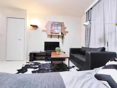 a living room with a bed and a couch and a table at 43\u65b0\u5bbf\u6700\u4e2d\u5fc3 \u65b0\u5bbf\u5fa1\u82d1\u524d\u7ad95\u5206-Shinjuku center 5 mins to Station, Max 3 \u76f4\u8fbe\u65b0\u5bbf \u6d89\u8c37 \u8868\u53c2\u9053 \u6c60\u888b \u4e0a\u91ce \u4ee3\u4ee3\u6728 \u94f6\u5ea7 \u539f\u5bbf in Tokyo