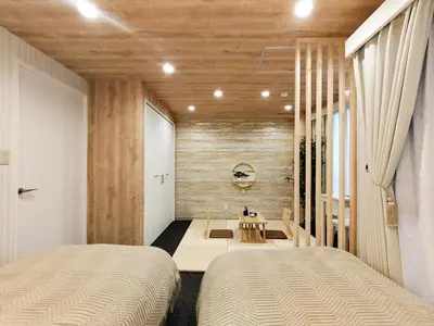 two beds in a room with wooden walls at 62\u65b0\u5bbf\u6700\u4e2d\u5fc3 \u65b0\u5bbf\u5fa1\u82d1\u524d\u7ad95\u5206-Shinjuku center 5 mins to Station, Max 5P \u65b0\u5bbf \u6d89\u8c37 \u8868\u53c2\u9053 \u6c60\u888b \u4e0a\u91ce \u4ee3\u4ee3\u6728 \u94f6\u5ea7 \u539f\u5bbf in Tokyo