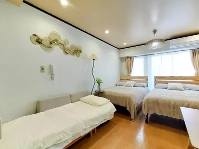 two beds in a room with white walls at S41\u6d89\u8c37\u6700\u4e2d\u5fc3 \u6d89\u8c37\u7ad97\u5206-Shibuya center 7 mins to Station, Max 5P \u76f4\u8fbe\u65b0\u5bbf \u6d89\u8c37 \u8868\u53c2\u9053 \u6c60\u888b \u4e0a\u91ce \u4ee3\u4ee3\u6728 \u94f6\u5ea7 \u539f\u5bbf in Tokyo