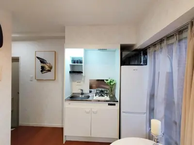 a kitchen with a sink and a white refrigerator at S13-Shibuya center 7 mins to Station, Max 4P\u6d89\u8c37\u6700\u4e2d\u5fc3 \u6d89\u8c37\u7ad97\u5206 in Tokyo