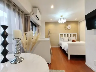 a bedroom with a bed and a table with a lamp at S13-Shibuya center 7 mins to Station, Max 4P\u6d89\u8c37\u6700\u4e2d\u5fc3 \u6d89\u8c37\u7ad97\u5206 in Tokyo