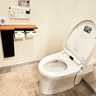 a bathroom with a toilet with the lid up at supiahouse in Tokyo
