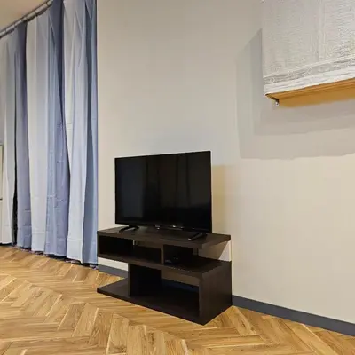 a flat screen tv sitting on a stand in a room at supiahouse in Tokyo
