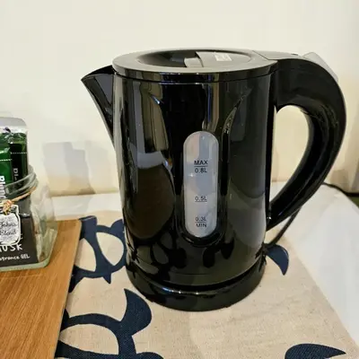a black coffee pot sitting on top of a table at supiahouse in Tokyo