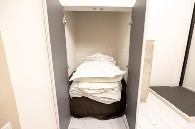 a room with a closet with a bed in it at Retaw Hills WASEDA in Tokyo
