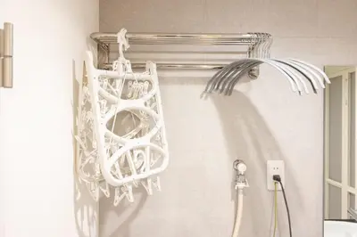 a white shower curtain holder in a bathroom at Retaw Hills WASEDA in Tokyo