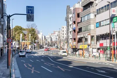 a city street with cars driving down the road at Retaw Hills WASEDA in Tokyo